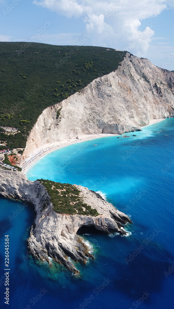 Obraz premium Aerial drone photo of popular tropical paradise deep turquoise beach of Porto Katsiki with white steep rocky seascape and beautiful cloudy landscape, Lefkada island, Ionian, Greece