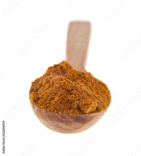 red pepper in a wooden spoon isolated on a white background. Ideal for packing.