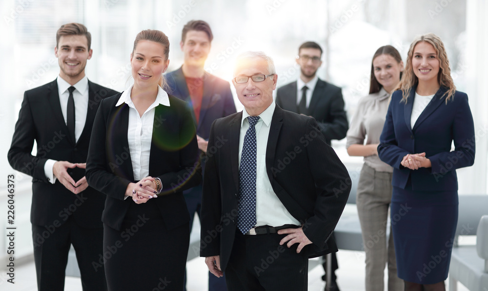 serious businessman and business woman on the background of the office staff. serious businessman and business woman on the background of the office staff.
