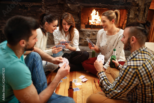 Young people playing cards on winter holiday #226047325