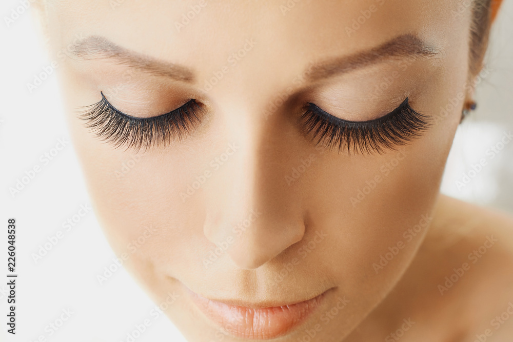 Beautiful girl with long false eyelashes and perfect skin. Eyelash extensions, cosmetology, beauty and skin care