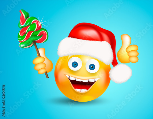 Happy smiling round face wearing a red santa claus hat holding christmas candies fir-tree and showing thumb up on bright blue background. Cartoon character. Icon