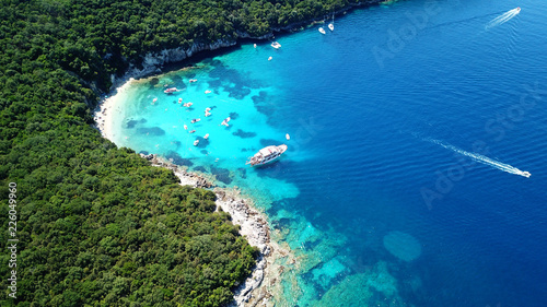 Aerial drone bird s eye view photo of iconic paradise sandy beach of blue lagoon with deep turquoise clear sea and pine trees  in complex island of Mourtos in Sivota area  Epirus  Greece