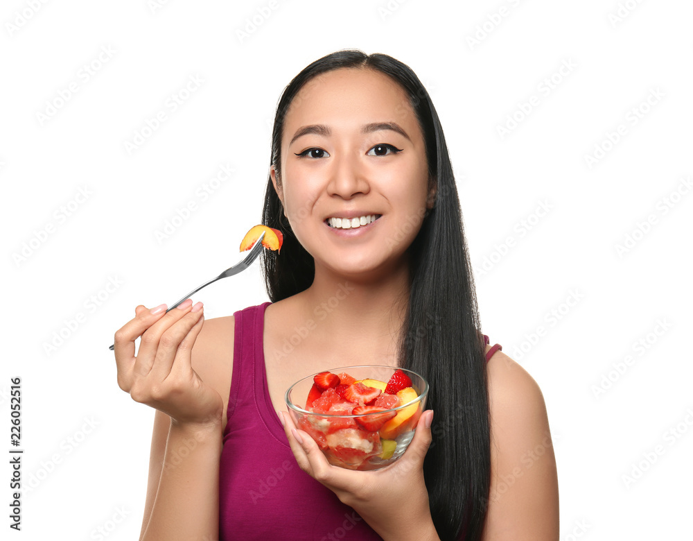 Asian woman with healthy fruit salad on white background Asian woman with healthy fruit salad on white background
