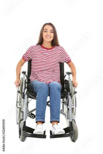 Young woman sitting in wheelchair on white background