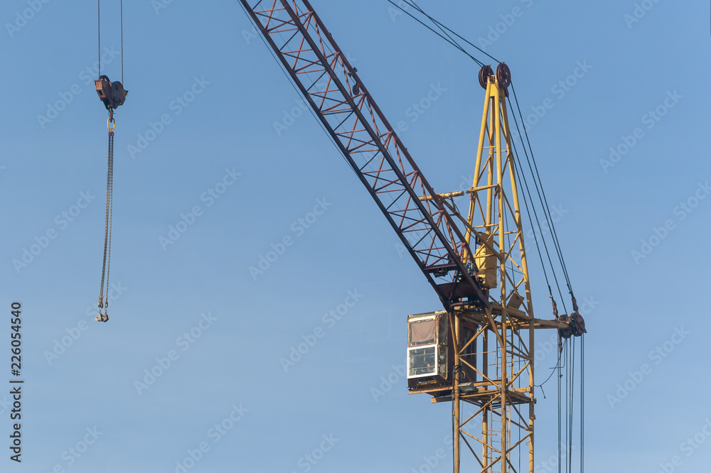 The upper part of the crane against the blue sky The upper part of the crane against the blue sky