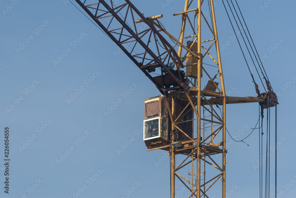 Cab of a construction crane against a blue sky Cab of a construction crane against a blue sky