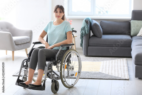 Young woman in wheelchair at home