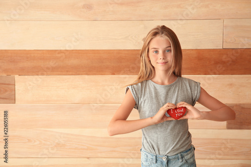 Cute little girl holding he...