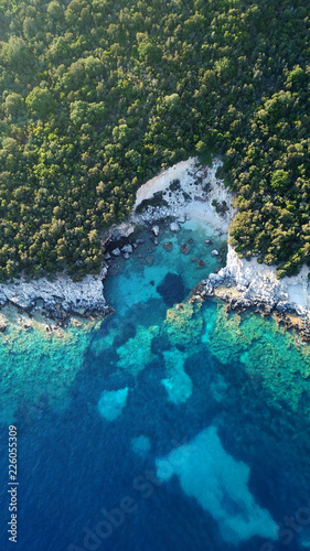 Aerial photo of tropical exotic paradise vegetated island with blue lagoon  white rocky beaches and turquoise sea