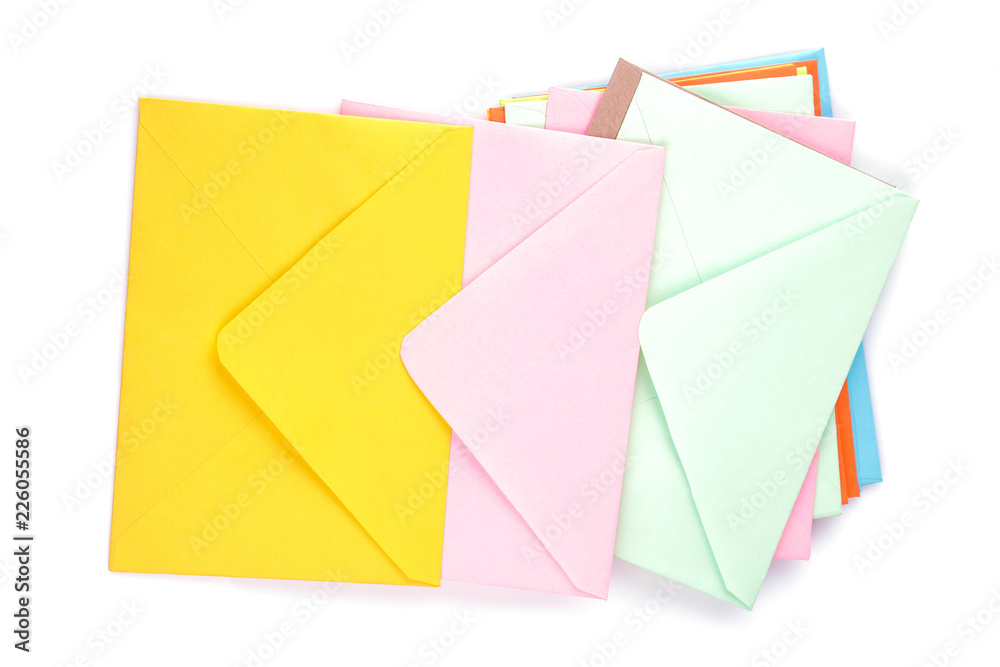 Many multicolored postal envelopes on a white isolated background. mail concept. top view