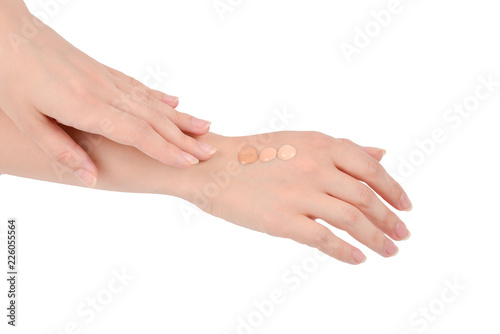 Fair  medium  dark swatches  of foundation on the hand isolated on white.