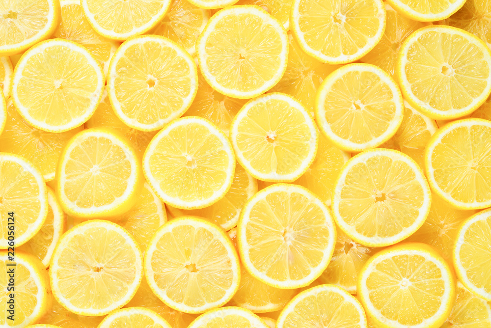 A slices of fresh juicy yellow lemons. Texture background, pattern. A slices of fresh juicy yellow lemons. Texture background, pattern.