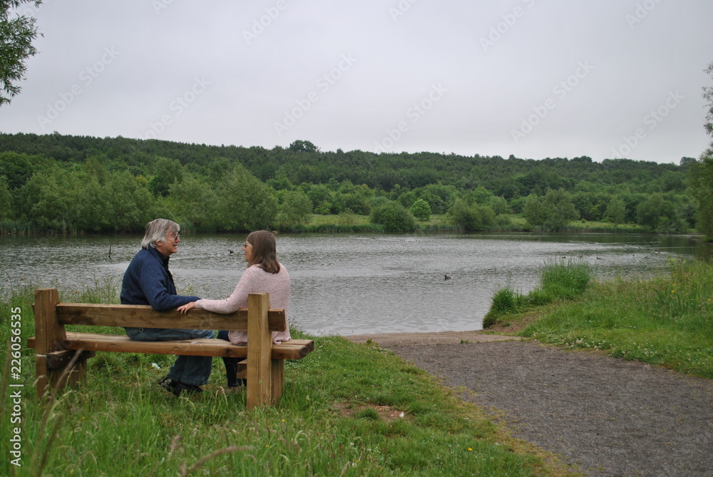 Man and Woman sitting on park bench Man and Woman sitting on park bench