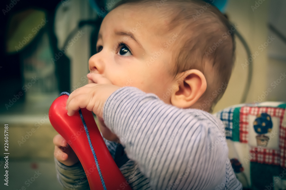 baby boy in the walker playing with phone baby boy in the walker playing with phone