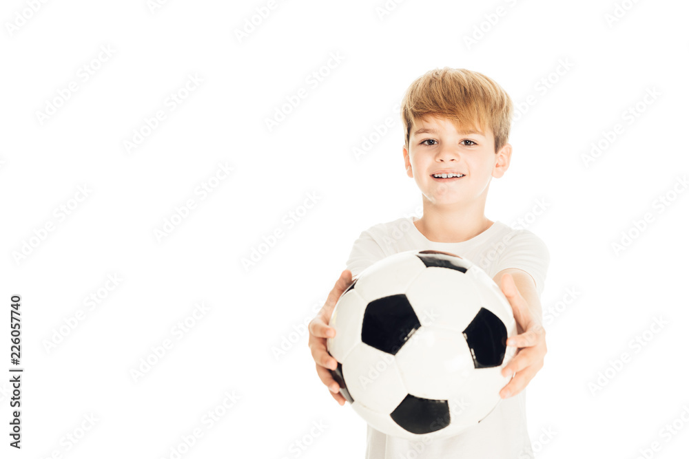 smiling adorable boy showing football ball isolated on white