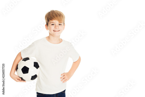 smiling adorable boy holding football ball and looking at camera isolated on white © LIGHTFIELD STUDIOS