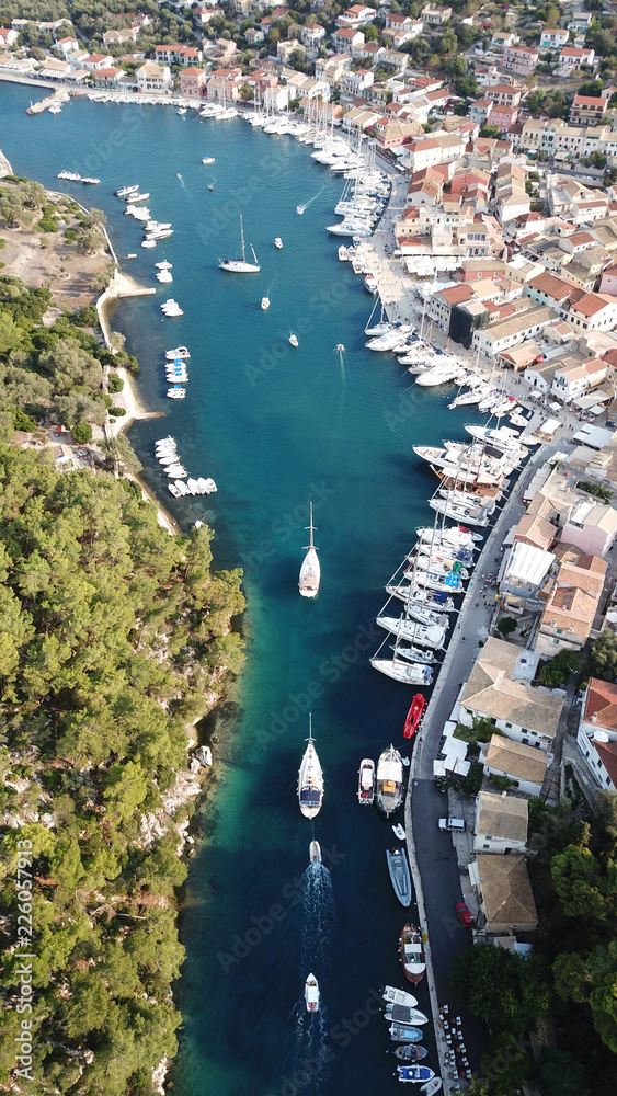 Aerial drone bird's eye view photo of iconic small safe port of Gaios with traditional Ionian architecture and sail boats docked, Paxos island, Ionian, Greece