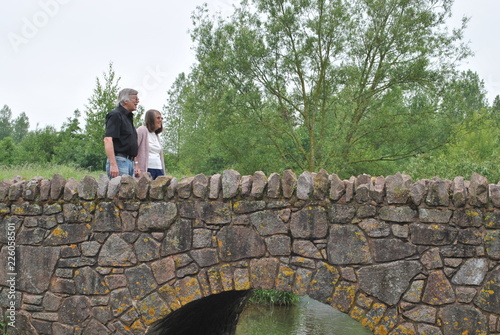 man and woman walking in park