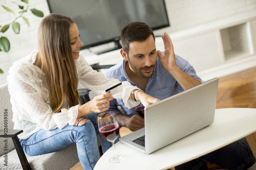 Cheerful couple searching internet and shopping online Cheerful couple searching internet and shopping online