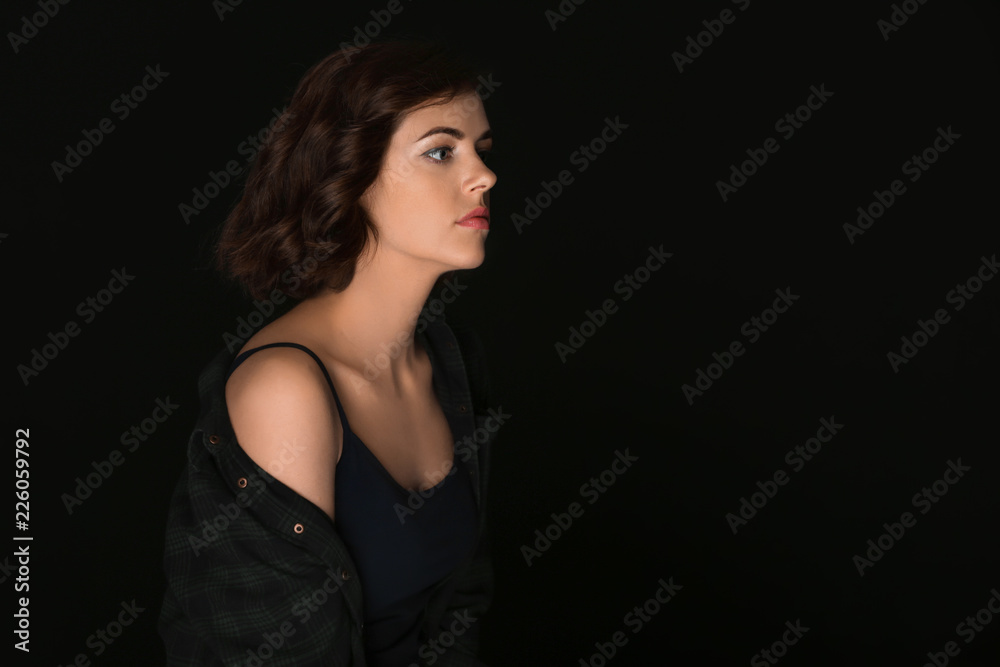 Portrait of beautiful young woman on dark background Portrait of beautiful young woman on dark background
