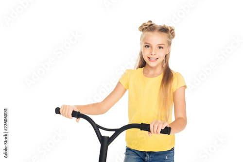 beautiful happy child holding scooter and smiling at camera isolated on white