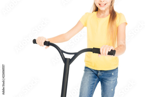 cropped shot of happy child holding scooter isolated on white