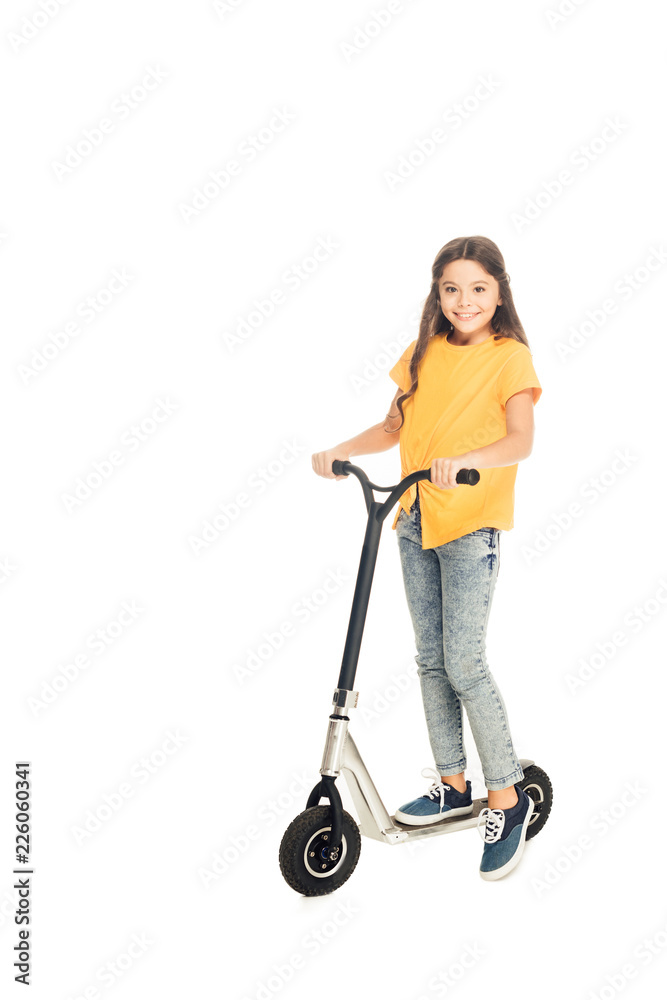 adorable happy child riding scooter and smiling at camera isolated on white adorable happy child riding scooter and smiling at camera isolated on white