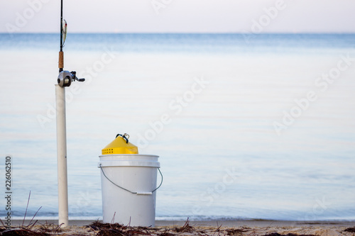 Fishing Tackle Rod Reel  & Bucket on the shore
