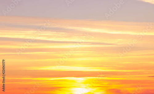 orange sunset abstraction. Blue sky, sun, clouds © Elena