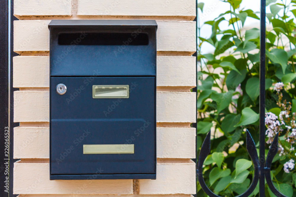 A beautiful mailbox hangs waiting for newspapers, parcels and letters.