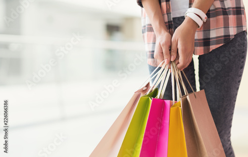 Young woman holding shopping bags in hands