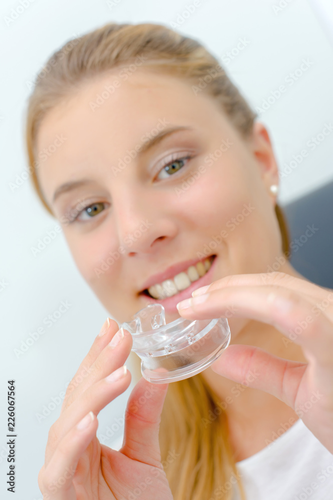 Woman about to use a mouth guard whilst at the dentist Woman about to use a mouth guard whilst at the dentist
