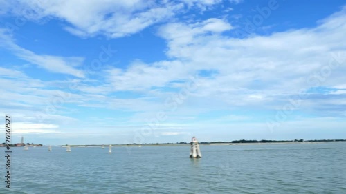 VENICE, ITALY - JULY 7, 2018: view from the sea to the Venetian islands. blue sea, sky, summer day. Burano Island, Murano Island, San Michele Island, San Giorgio Maggiore Island, San Servolo Island photo