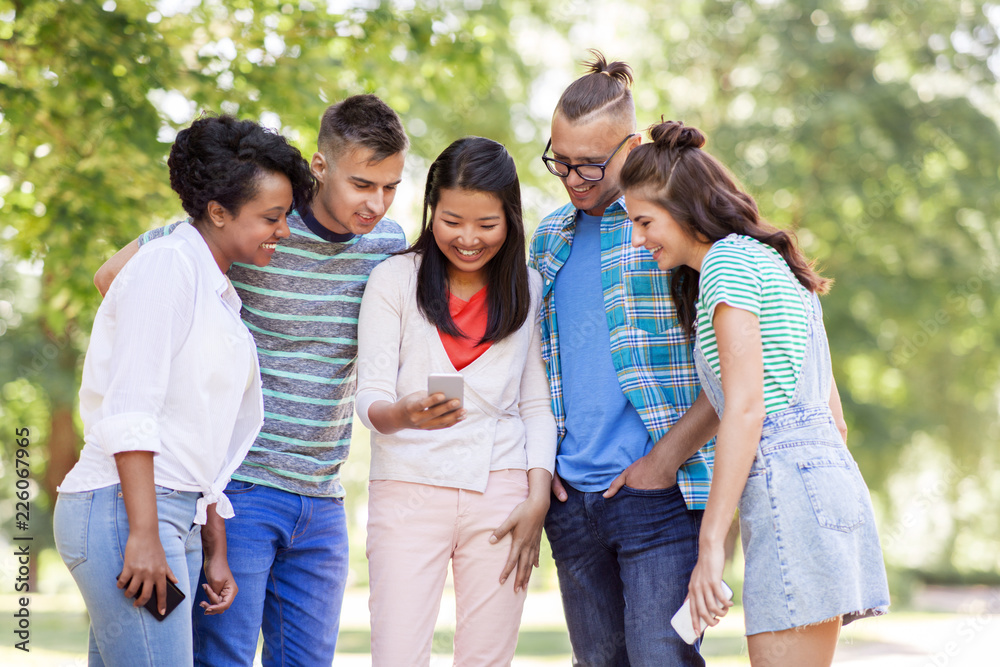 friendship, technology and international concept - group of happy smiling with smartphone outdoors friendship, technology and international concept - group of happy smiling with smartphone outdoors
