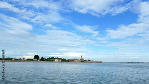 VENICE, ITALY - JULY 7, 2018: view from the sea to the Venetian islands. blue sea, sky, summer day. Burano Island, Murano Island, San Michele Island, San Giorgio Maggiore Island, San Servolo Island photo