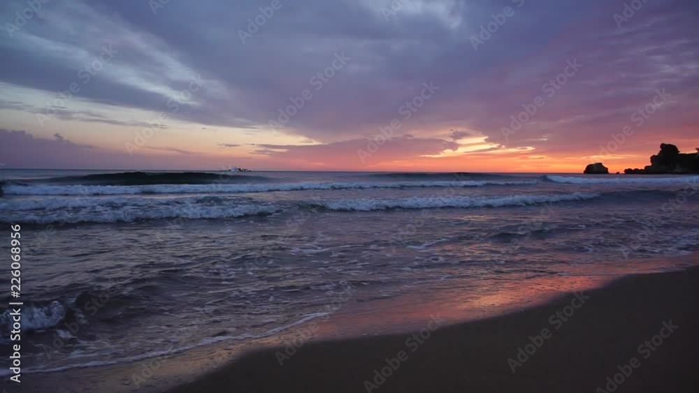 Colorful sunset sky reflected on water and sand in beautiful beach Colorful sunset sky reflected on water and sand in beautiful beach