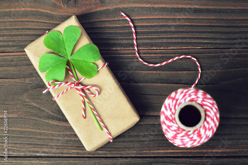 Christmas gift wrapped in craft paper decorated with clover photo