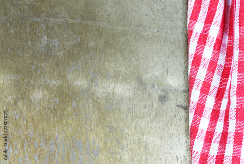 Red checkered napkin on rusty background