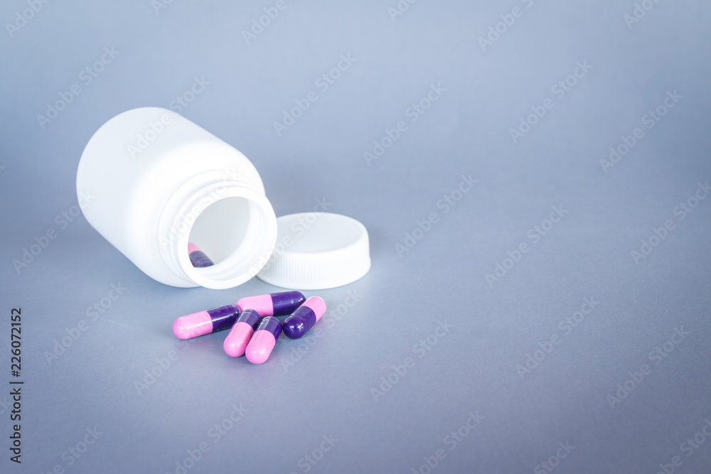 pills and tablets on grey background with bottle pills and tablets on grey background with bottle
