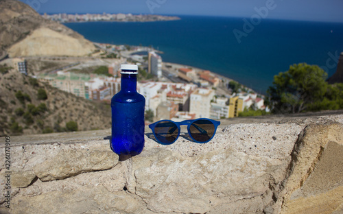 water in a bottle, sunglasses, a magnificent view at the sea, Spain of Alicante