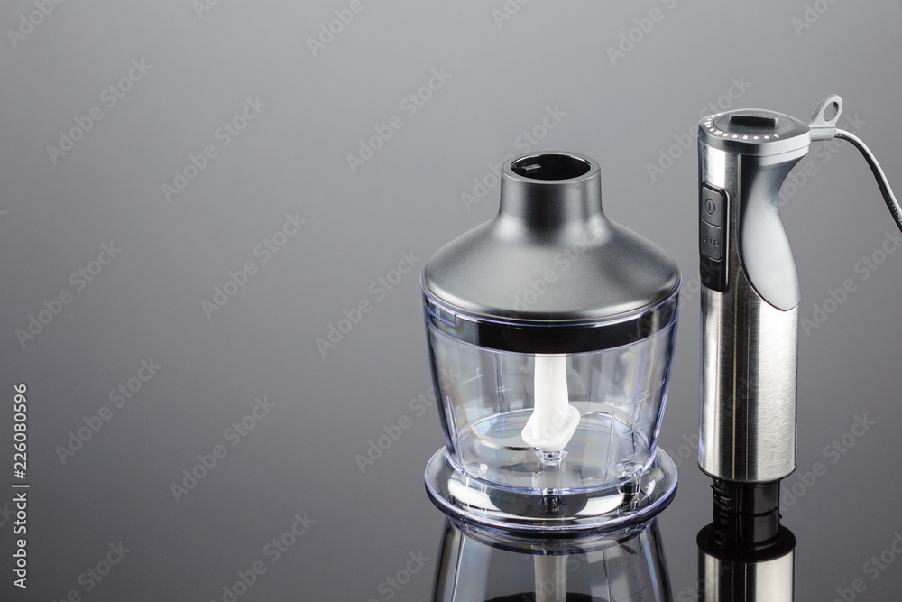 Blender with accessory on the grey mirror background Blender with accessory on the grey mirror background
