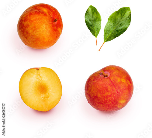 Yellow and orange plums (variety known as honey or mirabelle) isolated on white background. They include whole plums, segments and leaves. Color yellow, orange, orange. 