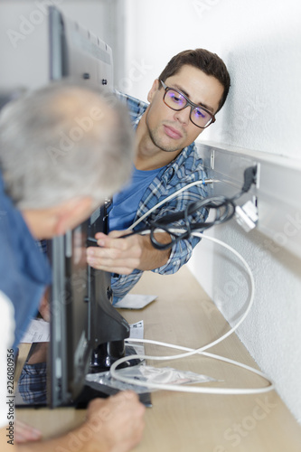 ethernet cable being plugged into a wall socket