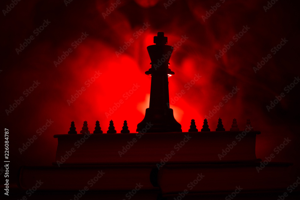 Chess board game concept of business ideas and competition or strategy ideas concept. Chess figures on a dark toned foggy background. Chess board game concept of business ideas and competition or strategy ideas concept. Chess figures on a dark toned foggy background.