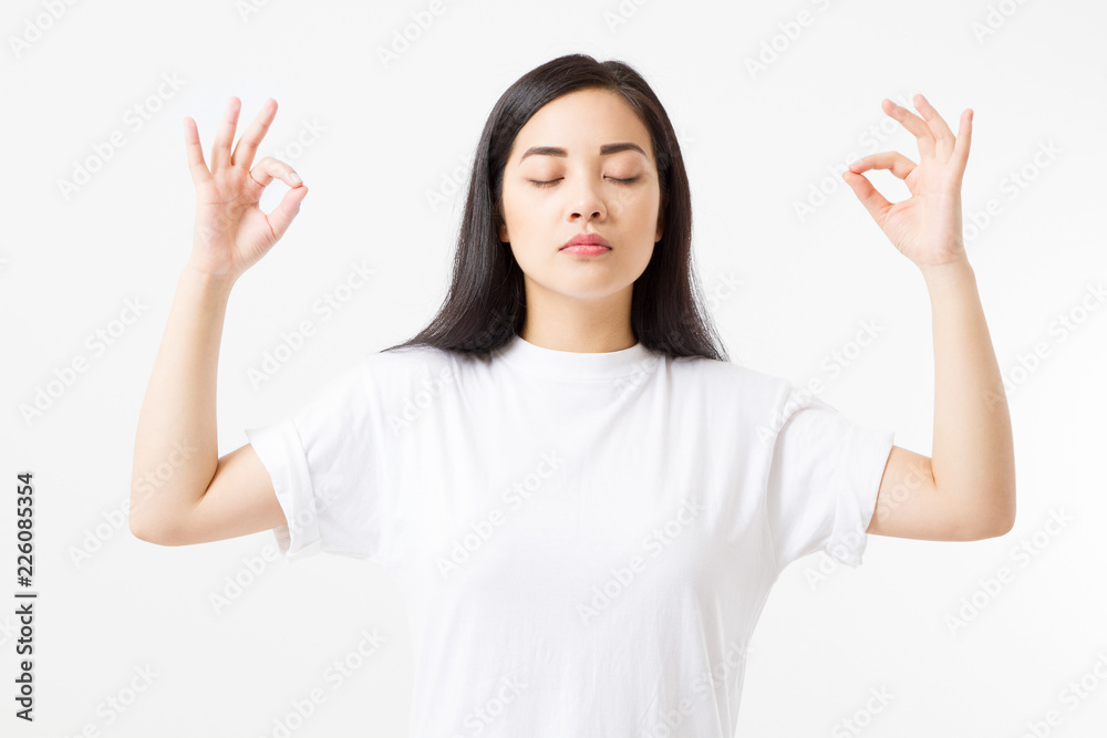 Zen sign. Calm asian girl in blank white t shirt isolated on template background. Copy space.