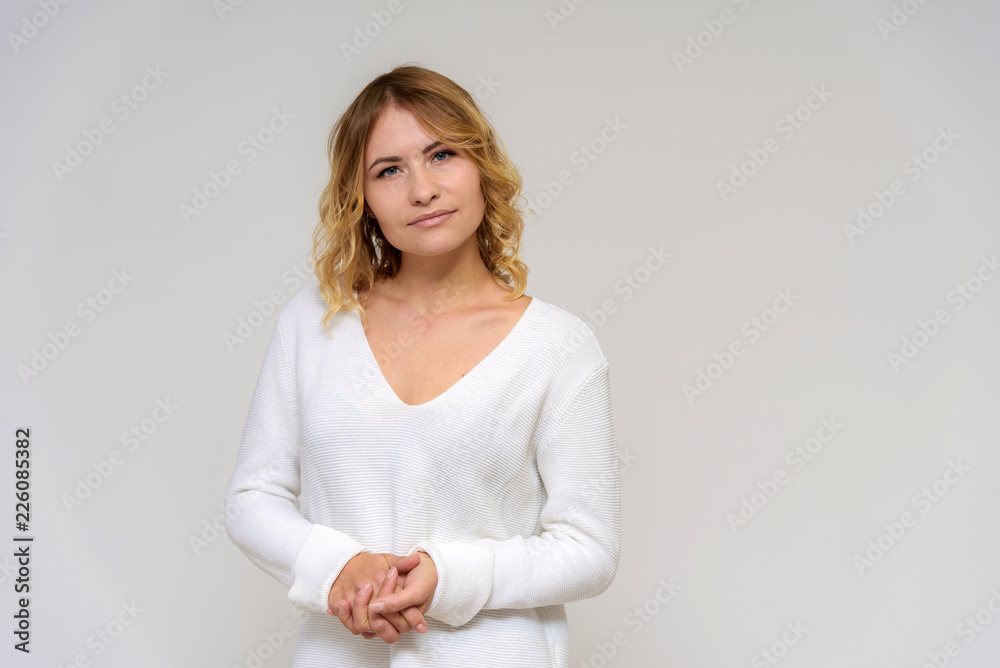 Portrait of a beautiful blonde girl on a white background in a dress. Portrait of a beautiful blonde girl on a white background in a dress.