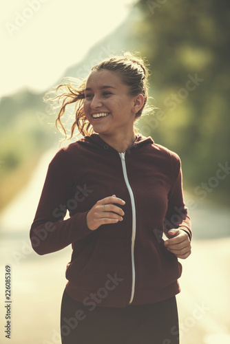 woman jogging along a country road