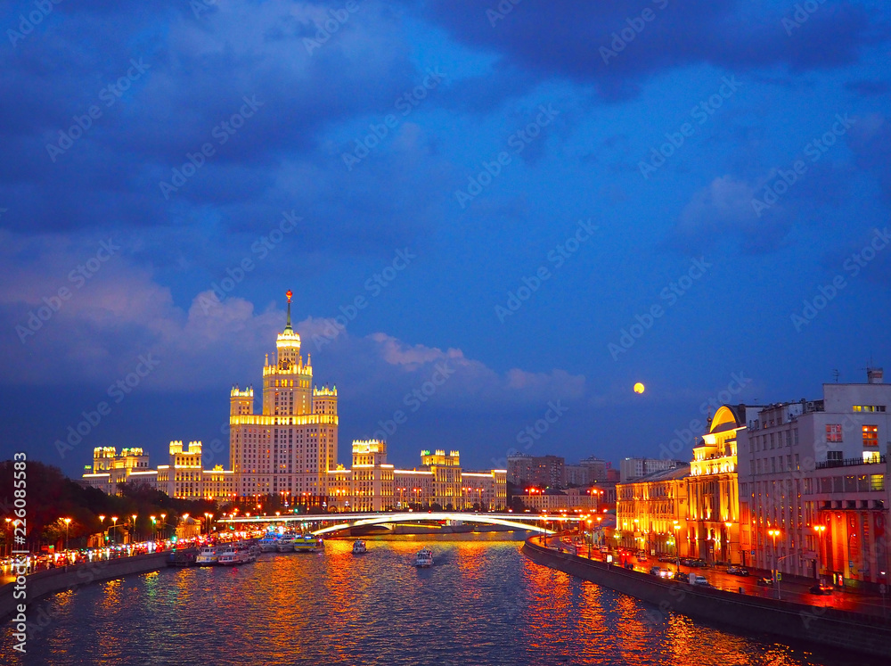 evening view on the river, a residential skyscraper on Kotelnicheskaya Embankment, Moscow River, Bolshoy Ustinsky bridge. Moscow, Russia