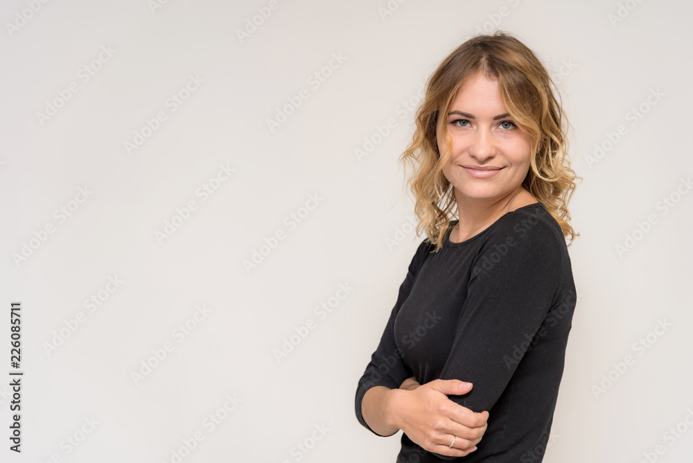 Portrait of a beautiful blonde girl on a white background in a dress. Portrait of a beautiful blonde girl on a white background in a dress.